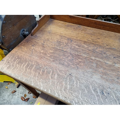 1185 - An early 20th century oak architect's desk, 137cm wide.