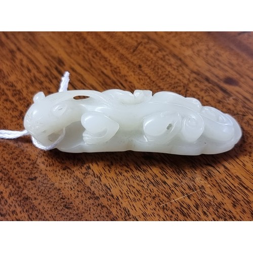 1657 - A good Chinese carved pale celadon jade beetle buckle, 5.7cm long; together with a Chinese carved pa... 