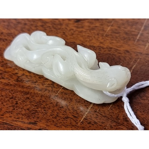 1657 - A good Chinese carved pale celadon jade beetle buckle, 5.7cm long; together with a Chinese carved pa... 