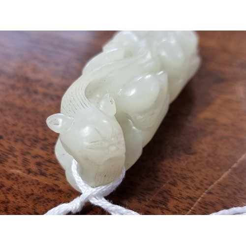 1657 - A good Chinese carved pale celadon jade beetle buckle, 5.7cm long; together with a Chinese carved pa... 