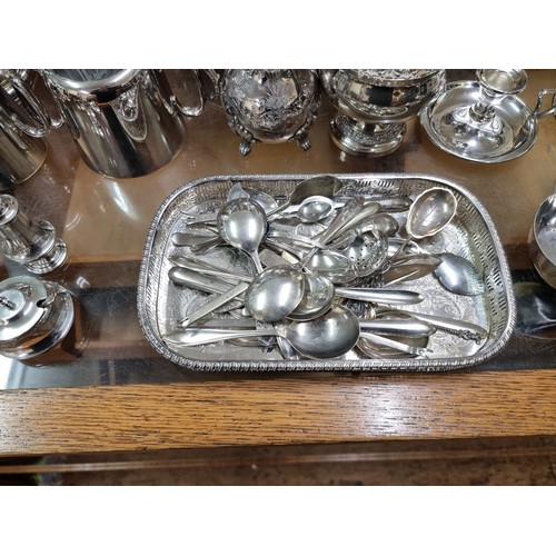 1014 - A quantity of silver plate, to include a four piece tea set; an entree dish; two chambersticks and v... 