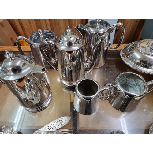 1014 - A quantity of silver plate, to include a four piece tea set; an entree dish; two chambersticks and v... 