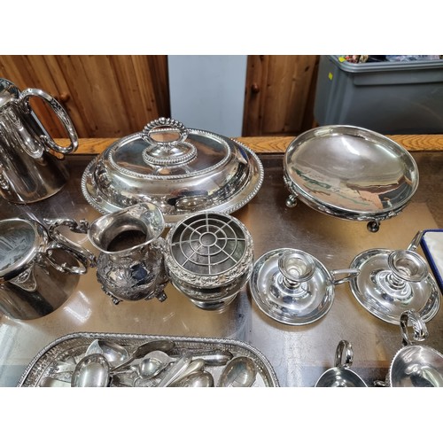 1014 - A quantity of silver plate, to include a four piece tea set; an entree dish; two chambersticks and v... 