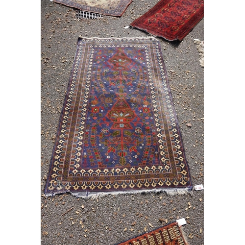 1076A - A Persian rug, central field decorated with two urns and flowers, 200 x 113cm.