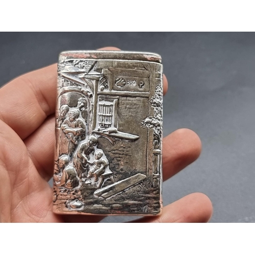 602 - A German white metal vesta case, Zwickau, stamped '830', embossed with tavern scenes, gross weight 5... 