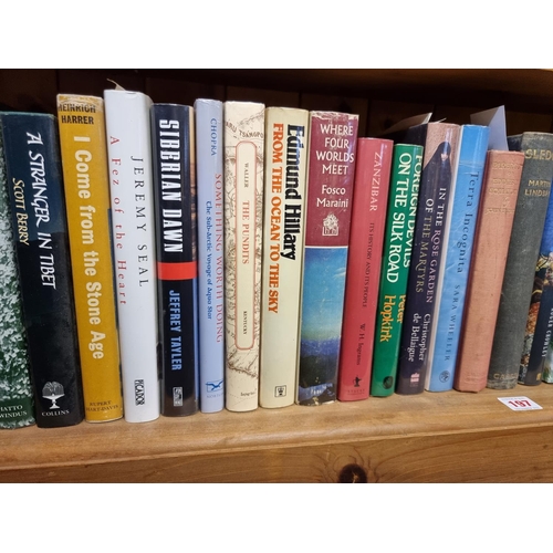 197 - TRAVEL/MOUNTAINEERING: a collection of 54 books across one shelf, mostly first editions in dustjacke... 