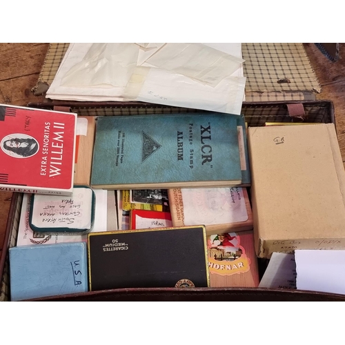 293 - STAMPS: a large and varied collection housed in numerous albums and tins. (Box and suitcase)... 