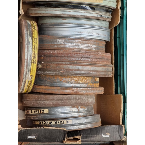 323 - FILM REELS: a large quantity of vintage film reels in metal tins, contained in 4 large boxes. (... 