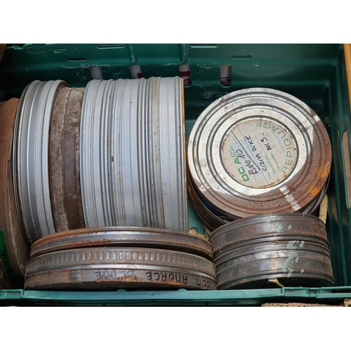 323 - FILM REELS: a large quantity of vintage film reels in metal tins, contained in 4 large boxes. (... 