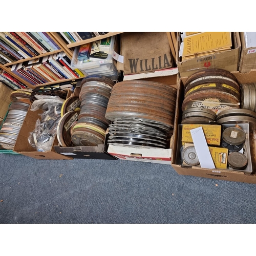 324 - FILM REELS: a large quantity of vintage film reels, many in metal tins, contained in 5 large boxes. ... 