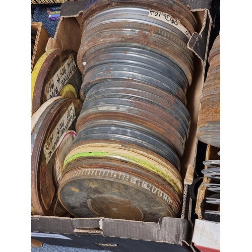 324 - FILM REELS: a large quantity of vintage film reels, many in metal tins, contained in 5 large boxes. ... 