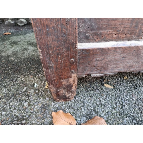 1004 - An early 18th century oak panelled coffer, 121cm wide.