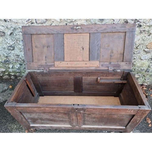 1004 - An early 18th century oak panelled coffer, 121cm wide.