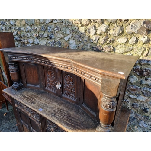 1006 - A 1950s oak court cupboard, 137.5cm wide. 