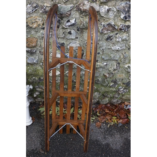 1048 - An old 'Davos' wood sledge, 108cm wide.