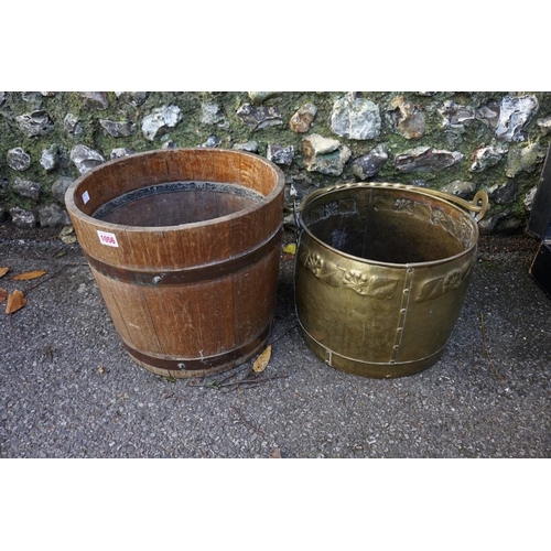 1056 - A brass swing handled log basket; together with another oak log bin.