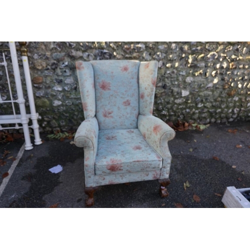 1061 - A wing armchair, having floral upholstery.