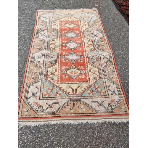 1075 - A Persian rug, having five central medallions, 205 x 122cm.