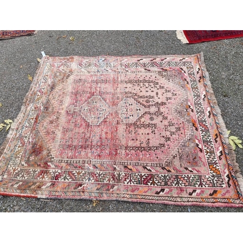 1079 - A Persian rug, having central geometric medallion, with geometric borders, (faded), 184 x 155cm.... 