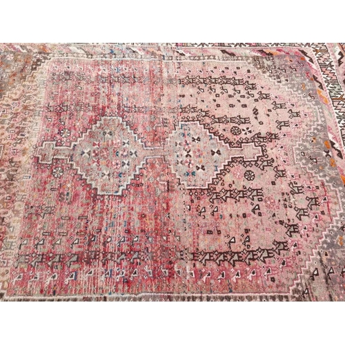 1079 - A Persian rug, having central geometric medallion, with geometric borders, (faded), 184 x 155cm.... 