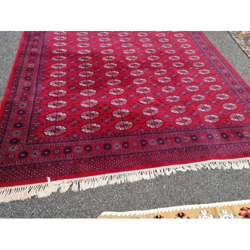 1080 - A large Bokhara carpet, on a red ground, 363 x 274cm.