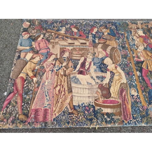 1081 - A tapestry wall hanging, depicting medieval figures making wine, 270 x 145cm.