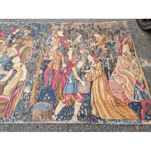 1081 - A tapestry wall hanging, depicting medieval figures making wine, 270 x 145cm.