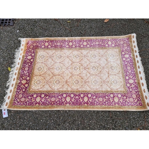 1082 - A Persian silk rug, having floral decoration, signed to one edge, 122 x 78cm.