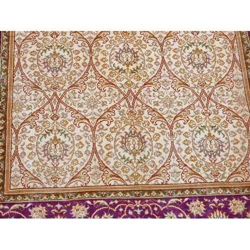 1082 - A Persian silk rug, having floral decoration, signed to one edge, 122 x 78cm.