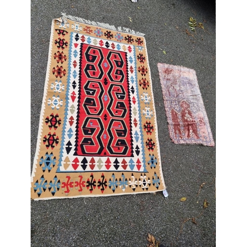 1084 - A tribal rug, 172 x 124cm; together with a silk prayer mat, decorated with temples, 98cm x 54cm. (2)... 