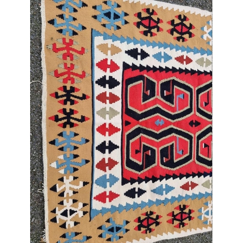 1084 - A tribal rug, 172 x 124cm; together with a silk prayer mat, decorated with temples, 98cm x 54cm. (2)... 