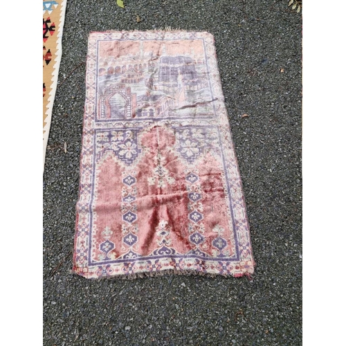 1084 - A tribal rug, 172 x 124cm; together with a silk prayer mat, decorated with temples, 98cm x 54cm. (2)... 