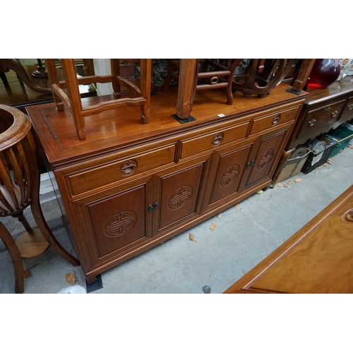 1095 - A Chinese hardwood side cabinet, with three frieze drawers above two pairs of cupboard doors, 150cm ... 