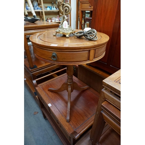 1101 - A small Chinese hardwood circular tripod drum table, with two frieze drawers, 52cm diameter; togethe... 