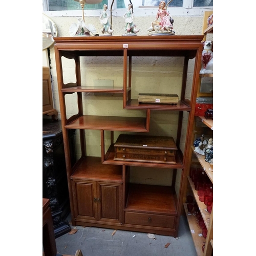 1103 - A Chinese hardwood display cabinet, of asymmetric form, 168 x 101cm. 