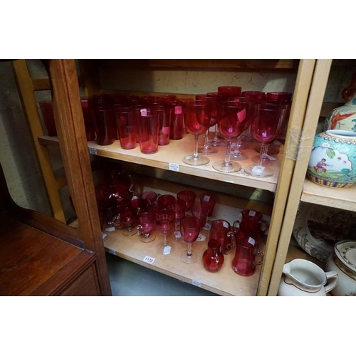 1132 - A large collection of Victorian cranberry glass. (two shelves)  