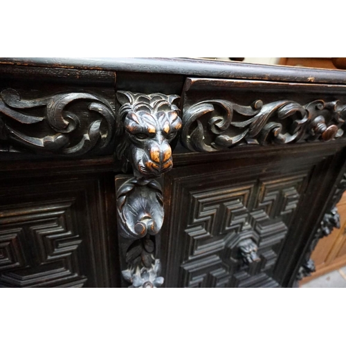 1144 - A late 19th century Flemish style carved and ebonized oak side cabinet, 142cm wide. ... 