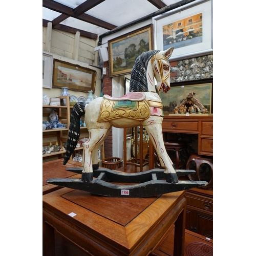 1150 - A small polychrome painted and carved wood rocking horse, 61cm high. 