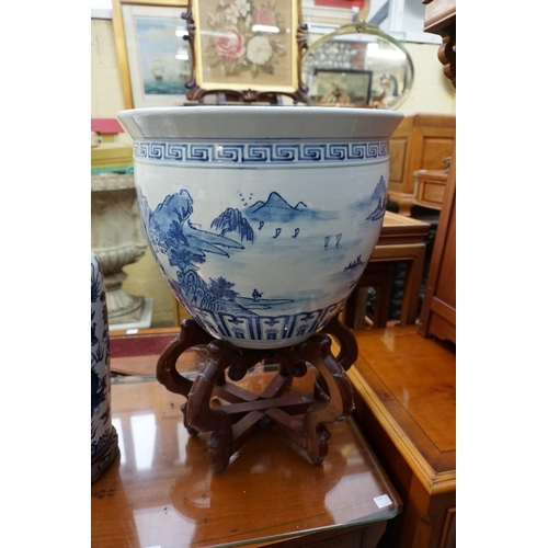 1156 - A Chinese blue and white fish bowl, 38cm diameter, on folding wood stand; together with another... 