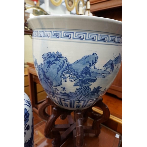 1156 - A Chinese blue and white fish bowl, 38cm diameter, on folding wood stand; together with another... 