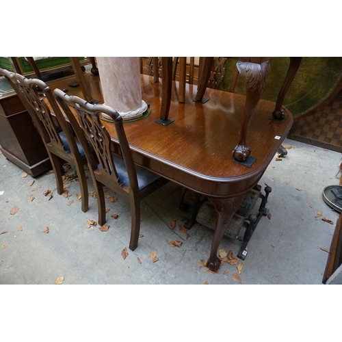 1183 - An early 20th century mahogany extending dining table and a set of six similar chairs, to include a ... 