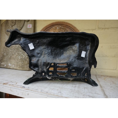 1202 - A painted cast iron cow doorstop, 36.5cm wide.