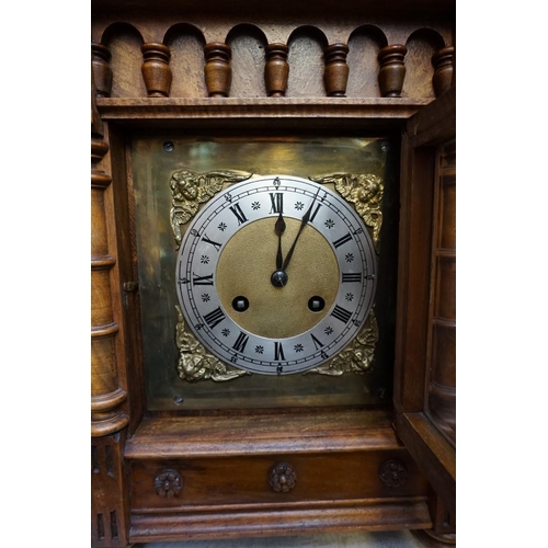 1210 - A late 19th century Continental walnut mantel clock, of architectural form, 43.5cm high, with pendul... 