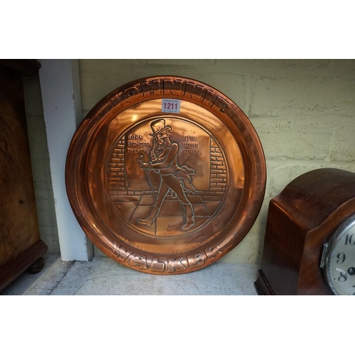 1211 - A copper 'Johnnie Walker' tray, 34cm diameter; together with another 'Vale of Conway Agricultur... 