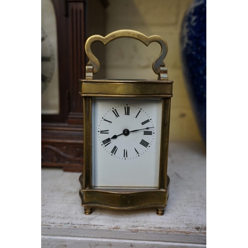 1223 - A vintage gilt brass easel timepiece, 12cm wide, (one hand detached); together with an old brass car... 