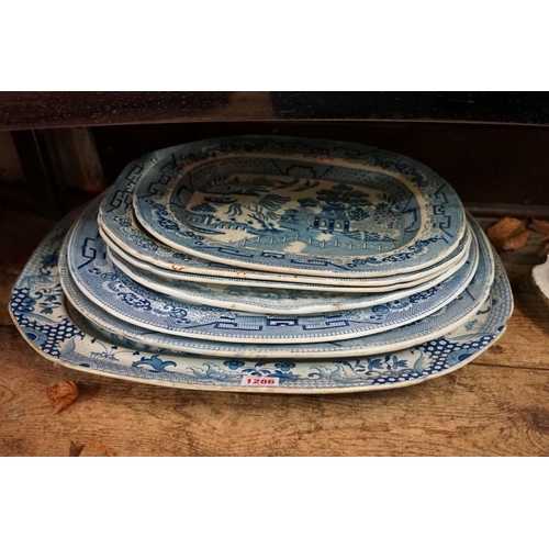 1286 - A collection of 19th century blue and white meat plates, to include a Davenport 'Well' example, 52cm... 