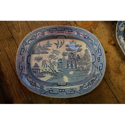 1286 - A collection of 19th century blue and white meat plates, to include a Davenport 'Well' example, 52cm... 