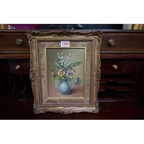 1289 - A Conway, still life of flowers in a blue vase, signed, Harrods label verso, oil on board, 20 x 14.5... 