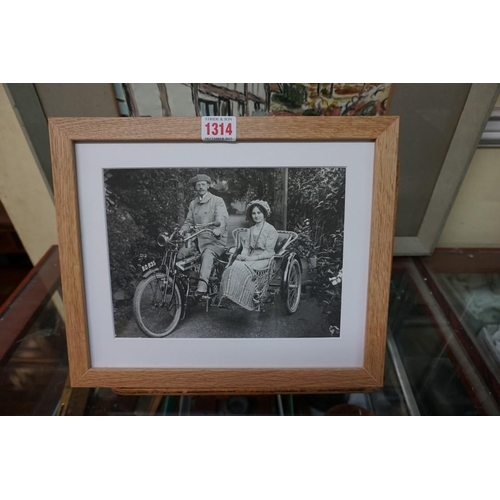 1314 - Automobilia: a black and white photograph of an early motorcycle and side car, with occupants, ... 