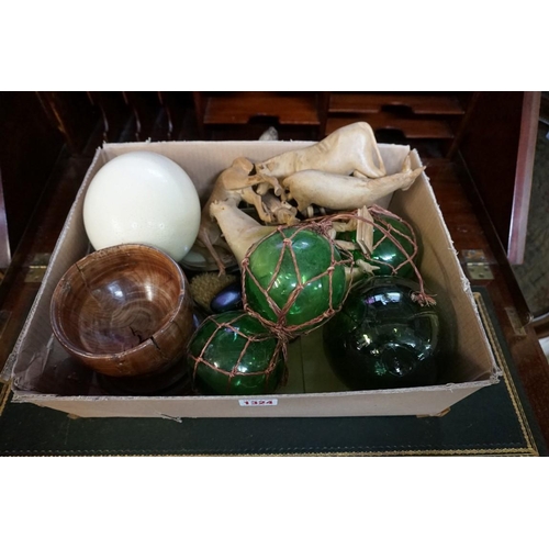 1324 - A mixed lot, to include four green glass fishing floats; and an ostrich egg, on turned wood stand.... 